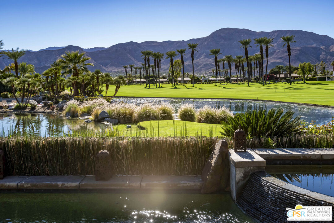 8 Surrey Court Rancho Mirage, CA 92270 - Photo 3 of 48 a view of a lake with a house in the background
