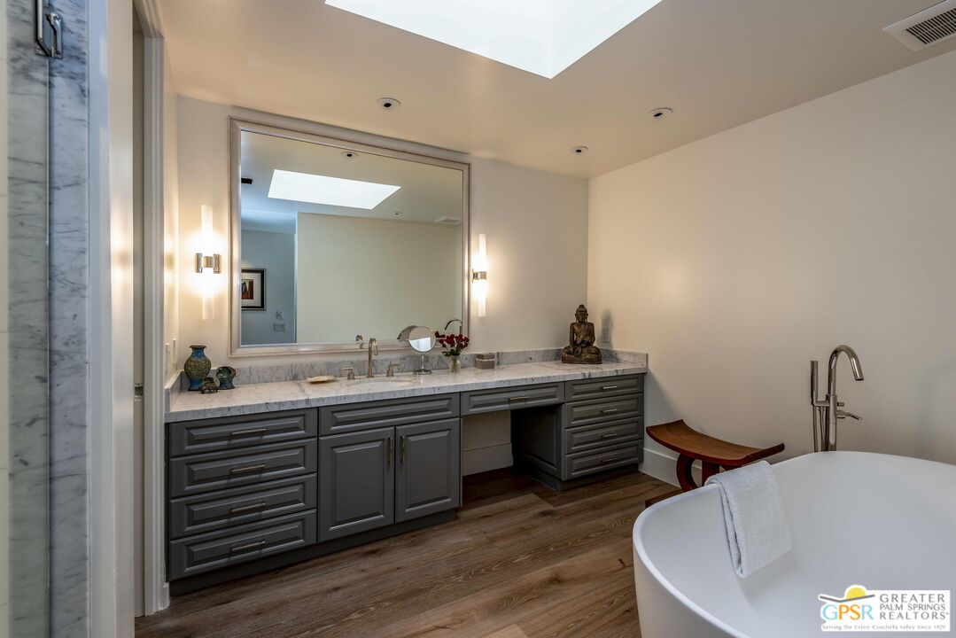 8 Surrey Court Rancho Mirage, CA 92270 - Photo 31 of 48 a bathroom with a double vanity sink and a large mirror