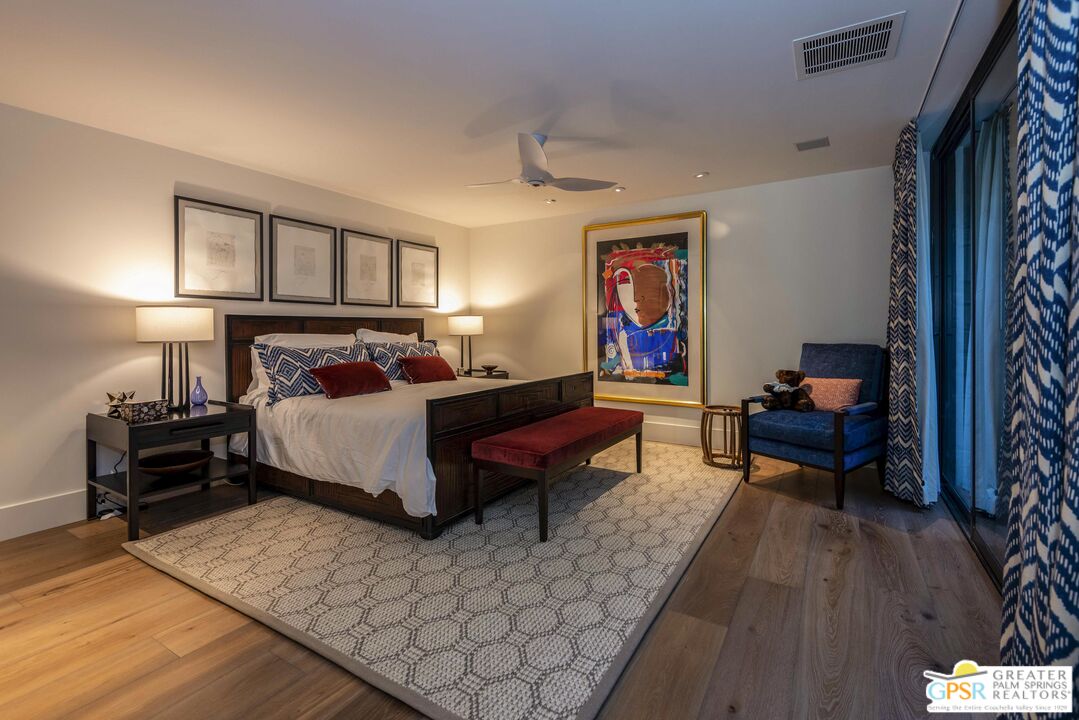 8 Surrey Court Rancho Mirage, CA 92270 - Photo 32 of 48 a bedroom with a bed and wooden floor