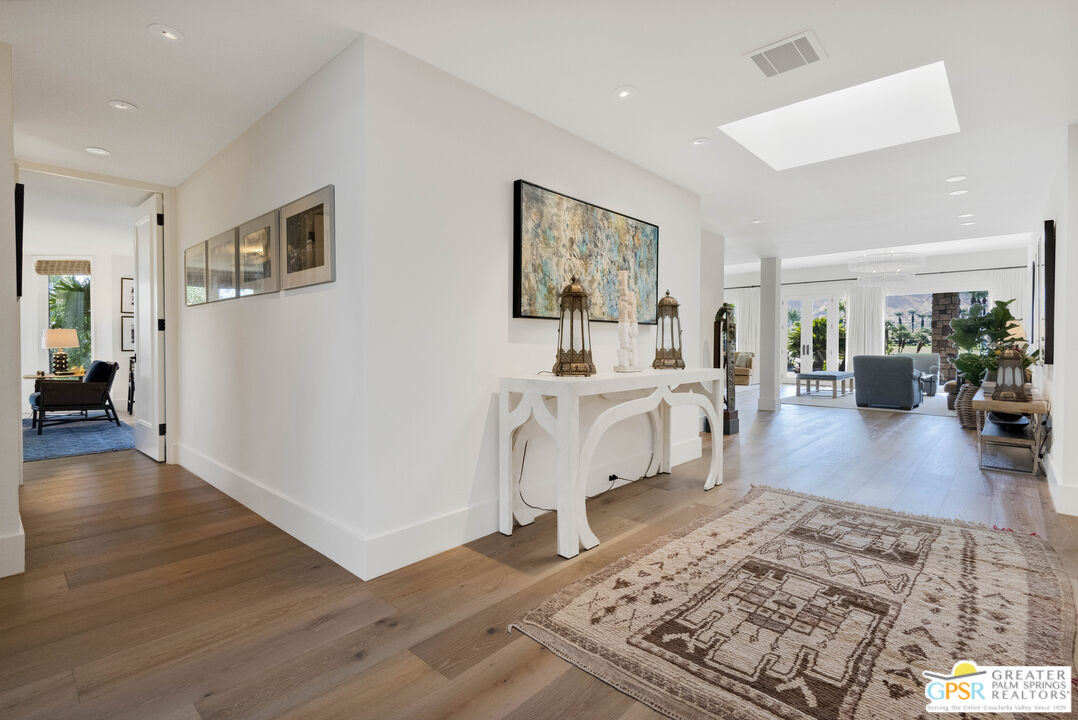 8 Surrey Court Rancho Mirage, CA 92270 - Photo 35 of 48 a living room with furniture and a wooden floor