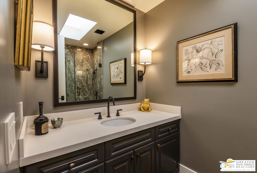 8 Surrey Court Rancho Mirage, CA 92270 - Photo 36 of 48 a bathroom with a sink and a mirror