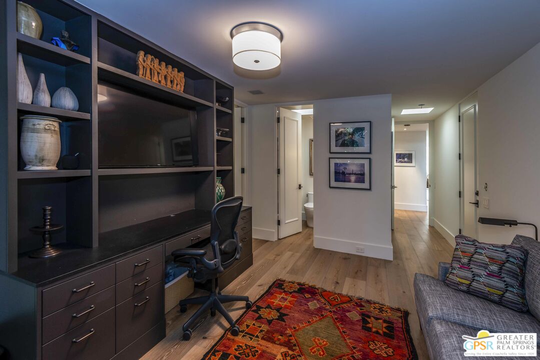 8 Surrey Court Rancho Mirage, CA 92270 - Photo 37 of 48 a living room with furniture and a flat screen tv