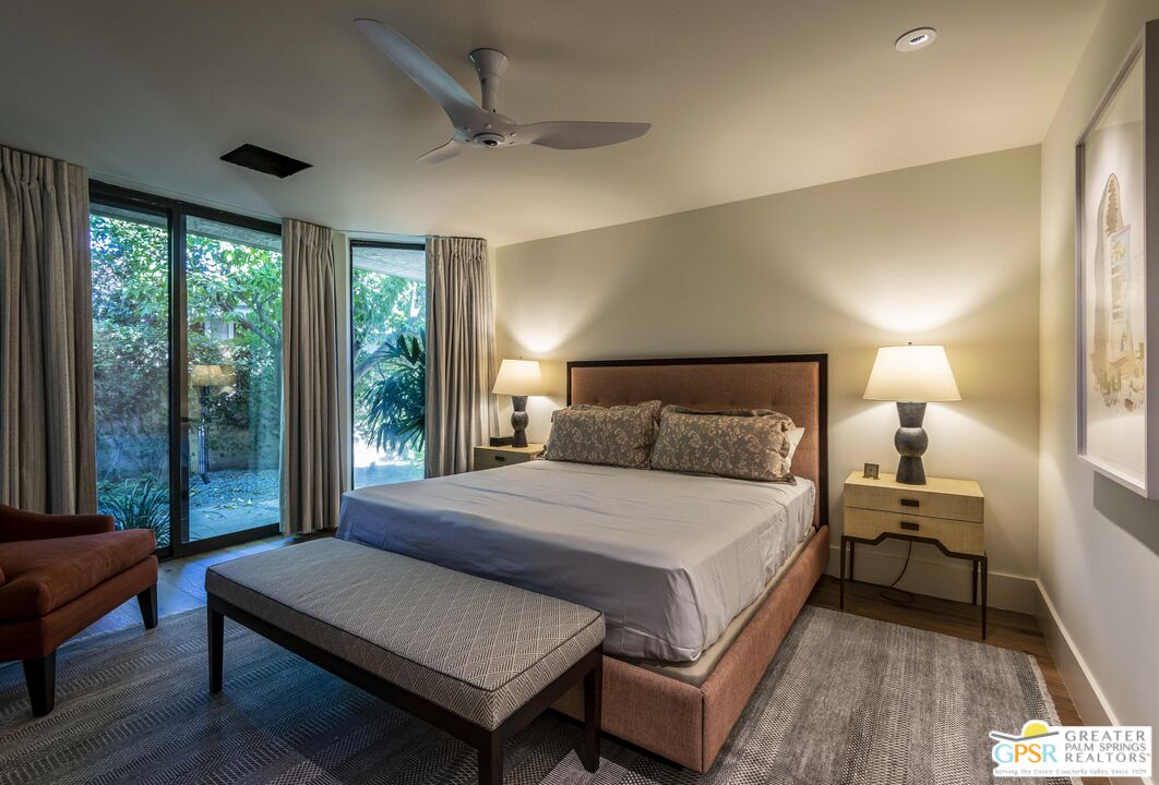 8 Surrey Court Rancho Mirage, CA 92270 - Photo 38 of 48 a bedroom with a bed wooden floor and window