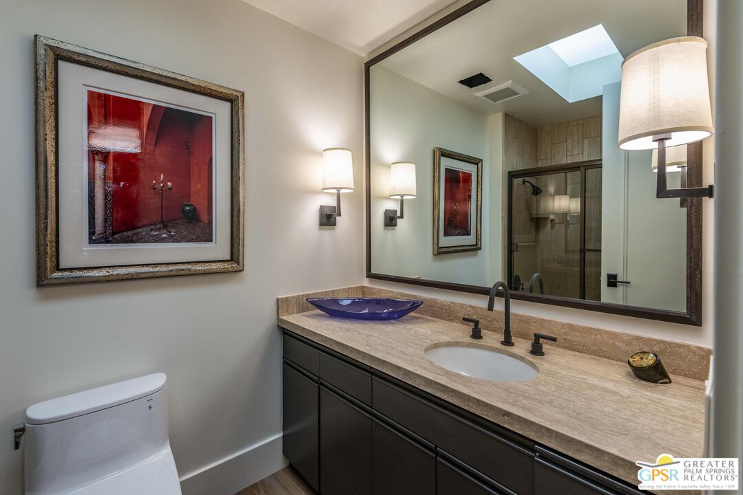 8 Surrey Court Rancho Mirage, CA 92270 - Photo 39 of 48 a bathroom with a granite countertop sink and a mirror