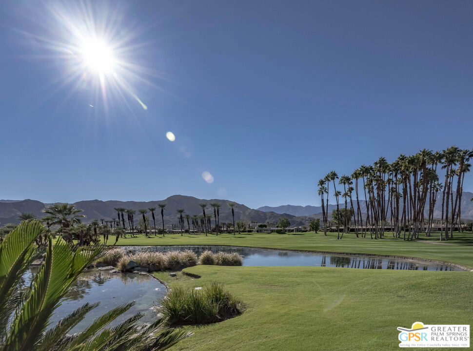 8 Surrey Court Rancho Mirage, CA 92270 - Photo 47 of 48 a view of a lake with a yard