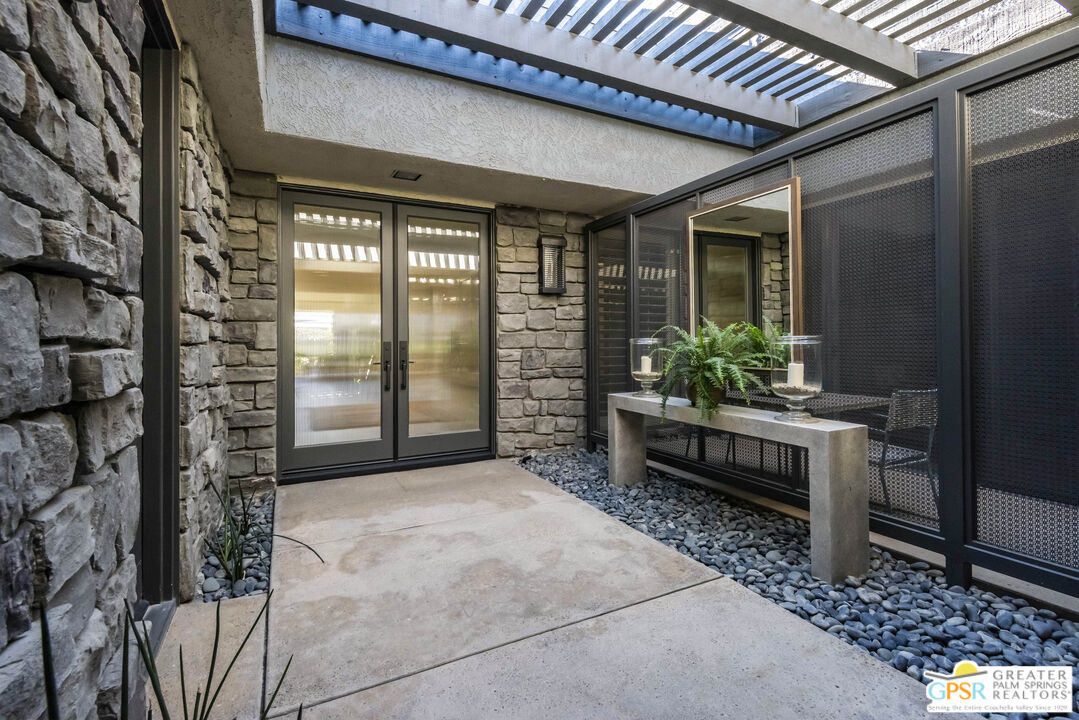 8 Surrey Court Rancho Mirage, CA 92270 - Photo 6 of 48 a view of a entryway door front of house