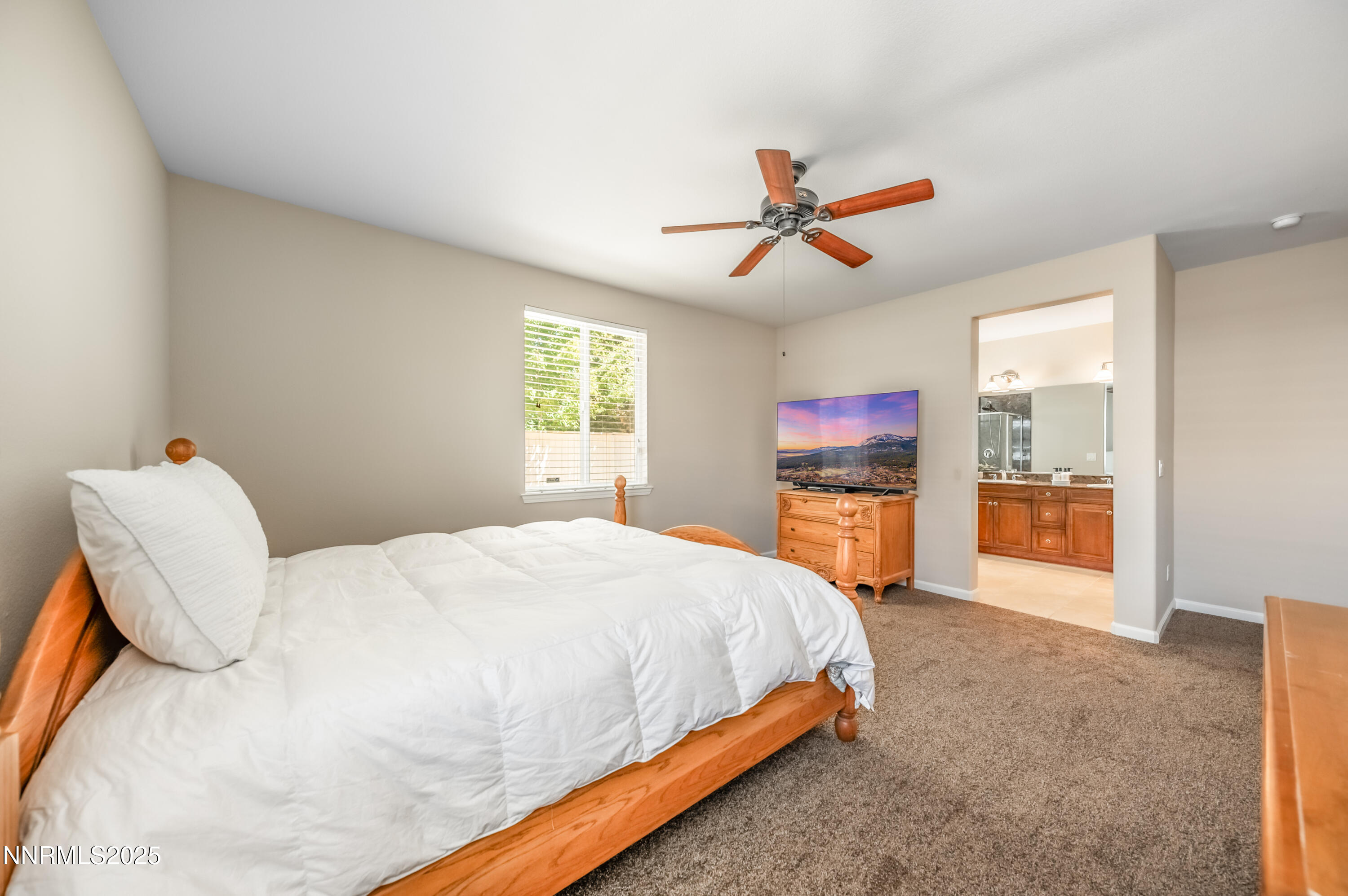 10742 Amber Falls Drive Reno, NV 89521 - Photo 13 of 28 a bedroom with a bed and dresser with mirror