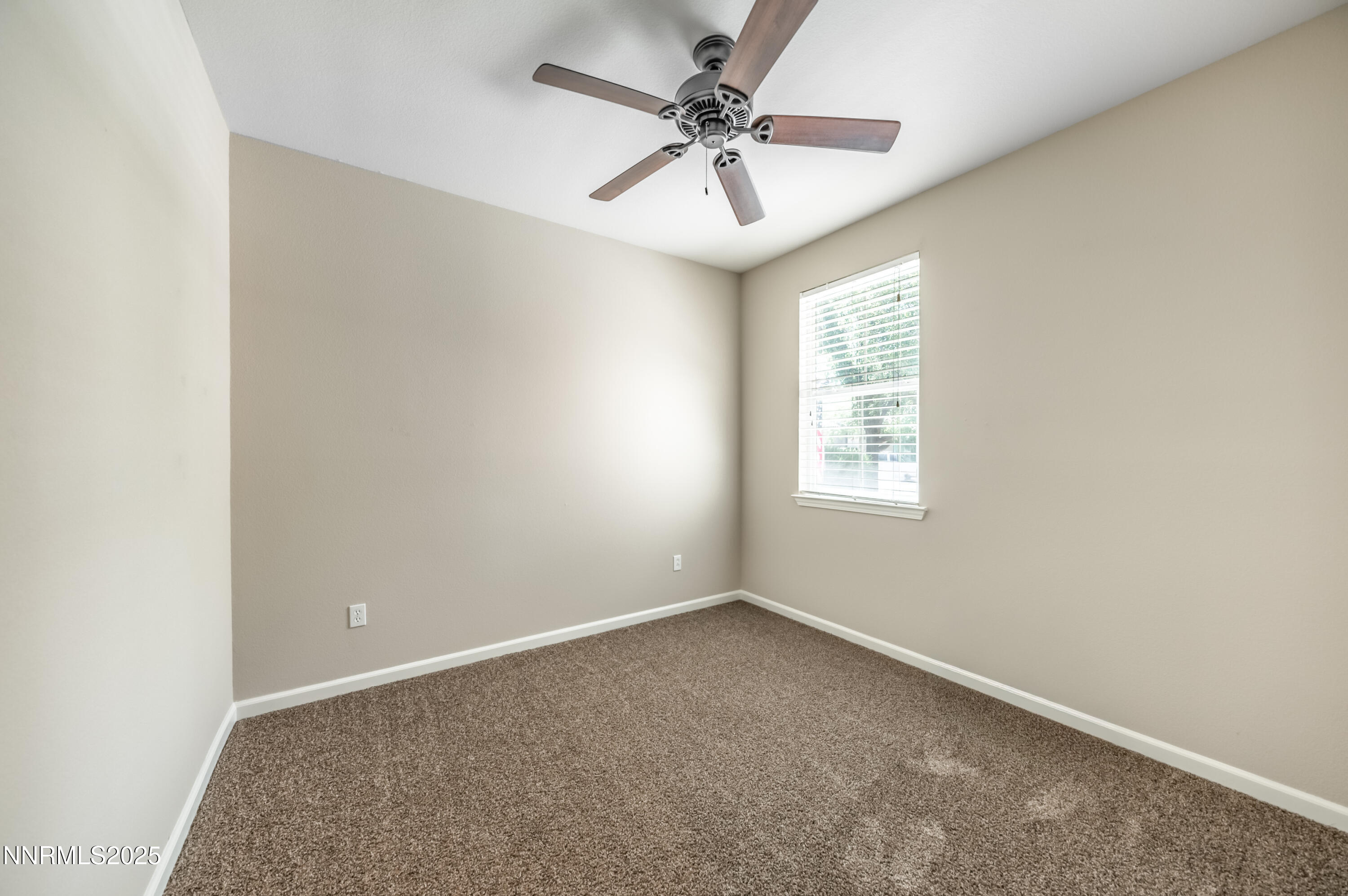 10742 Amber Falls Drive Reno, NV 89521 - Photo 18 of 28 an empty room with a window and a fan