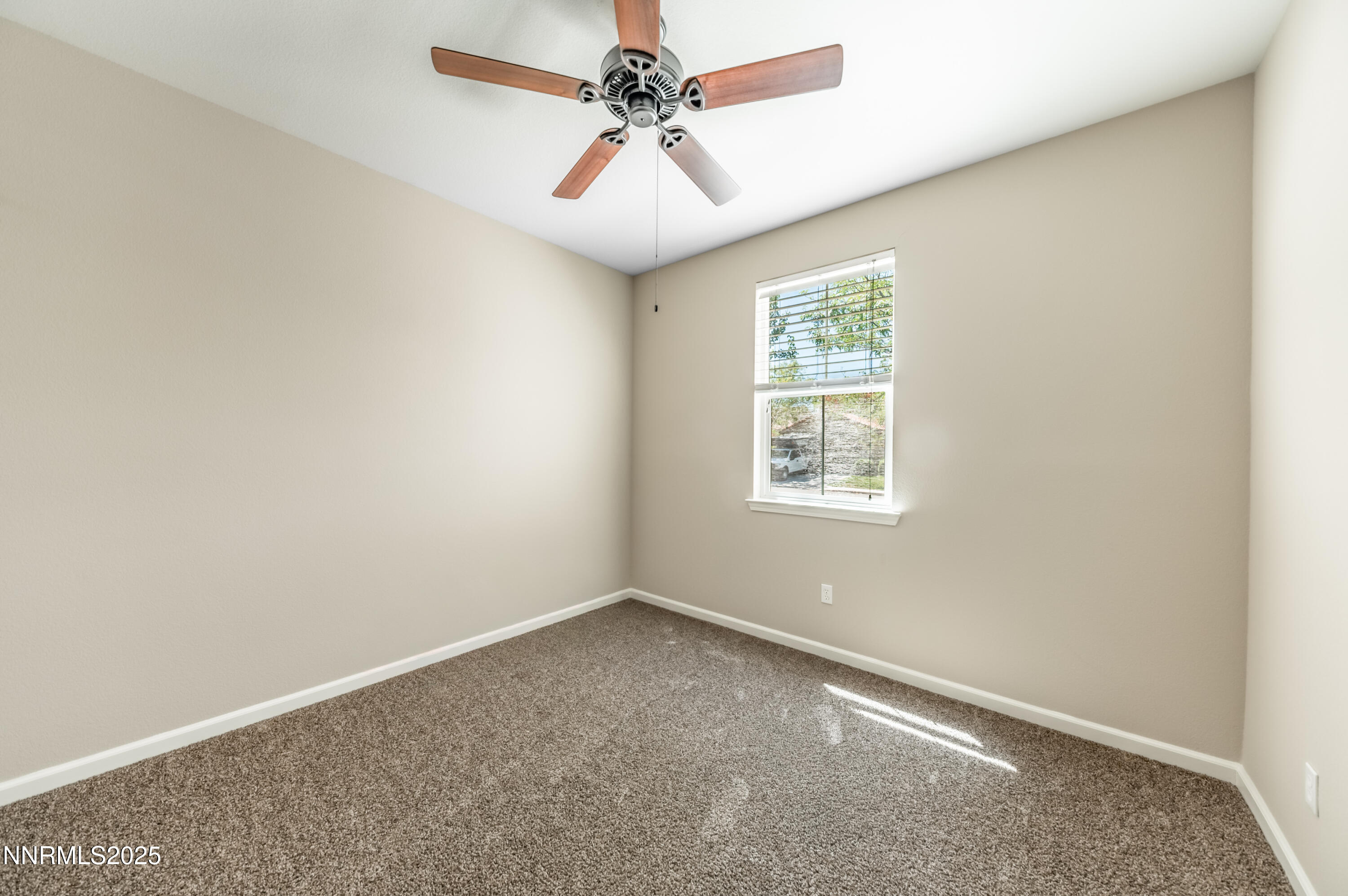 10742 Amber Falls Drive Reno, NV 89521 - Photo 20 of 28 an empty room with windows and fan