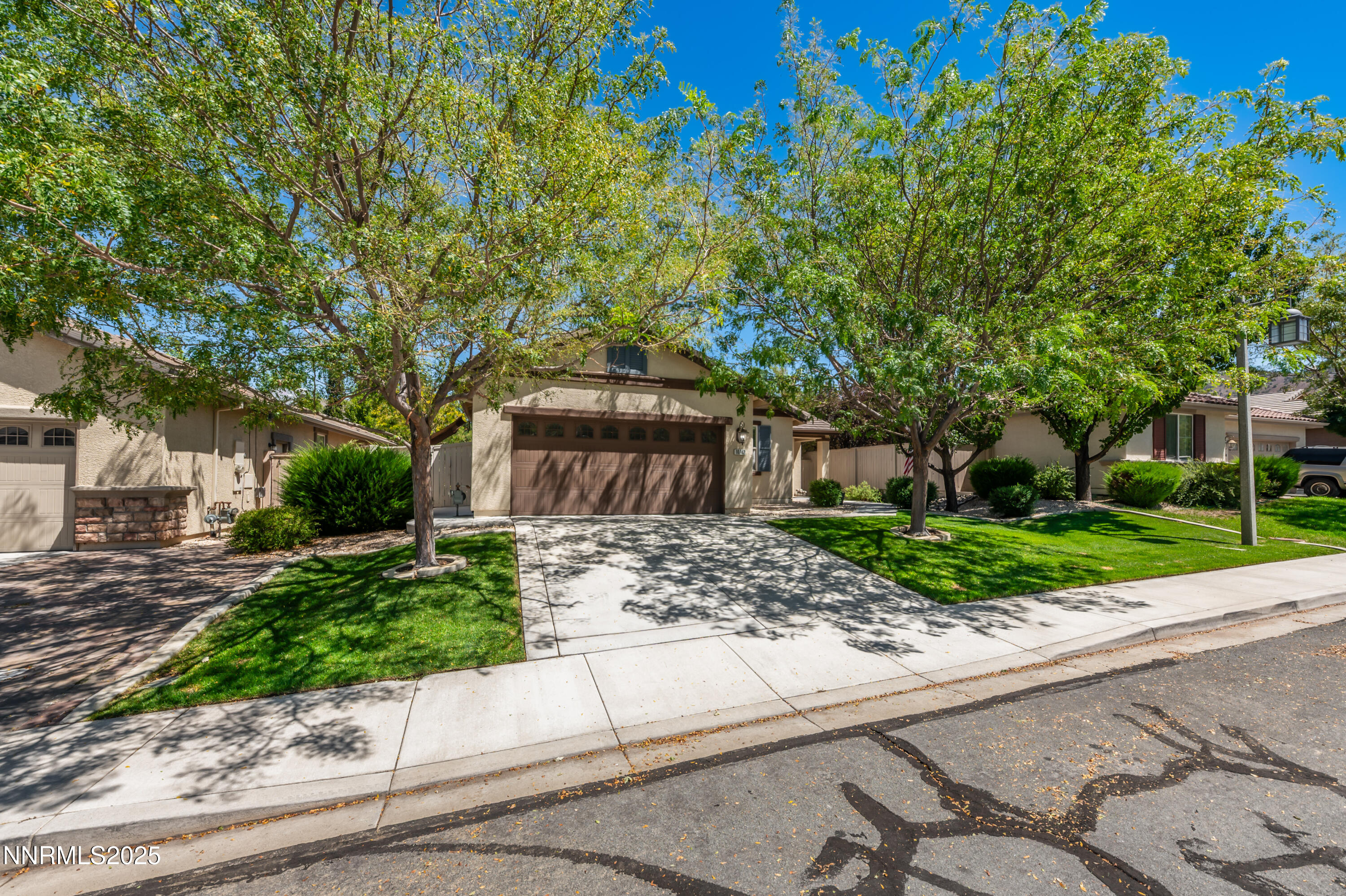 10742 Amber Falls Drive Reno, NV 89521 - Photo 2 of 28 a front view of a house with a garden