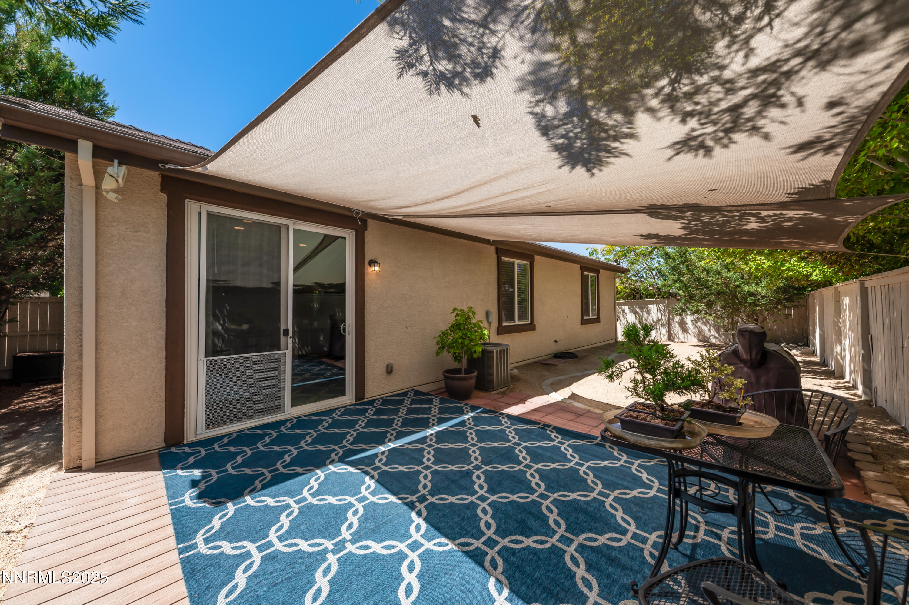 10742 Amber Falls Drive Reno, NV 89521 - Photo 25 of 28 a view of a backyard with table and chairs and potted plants