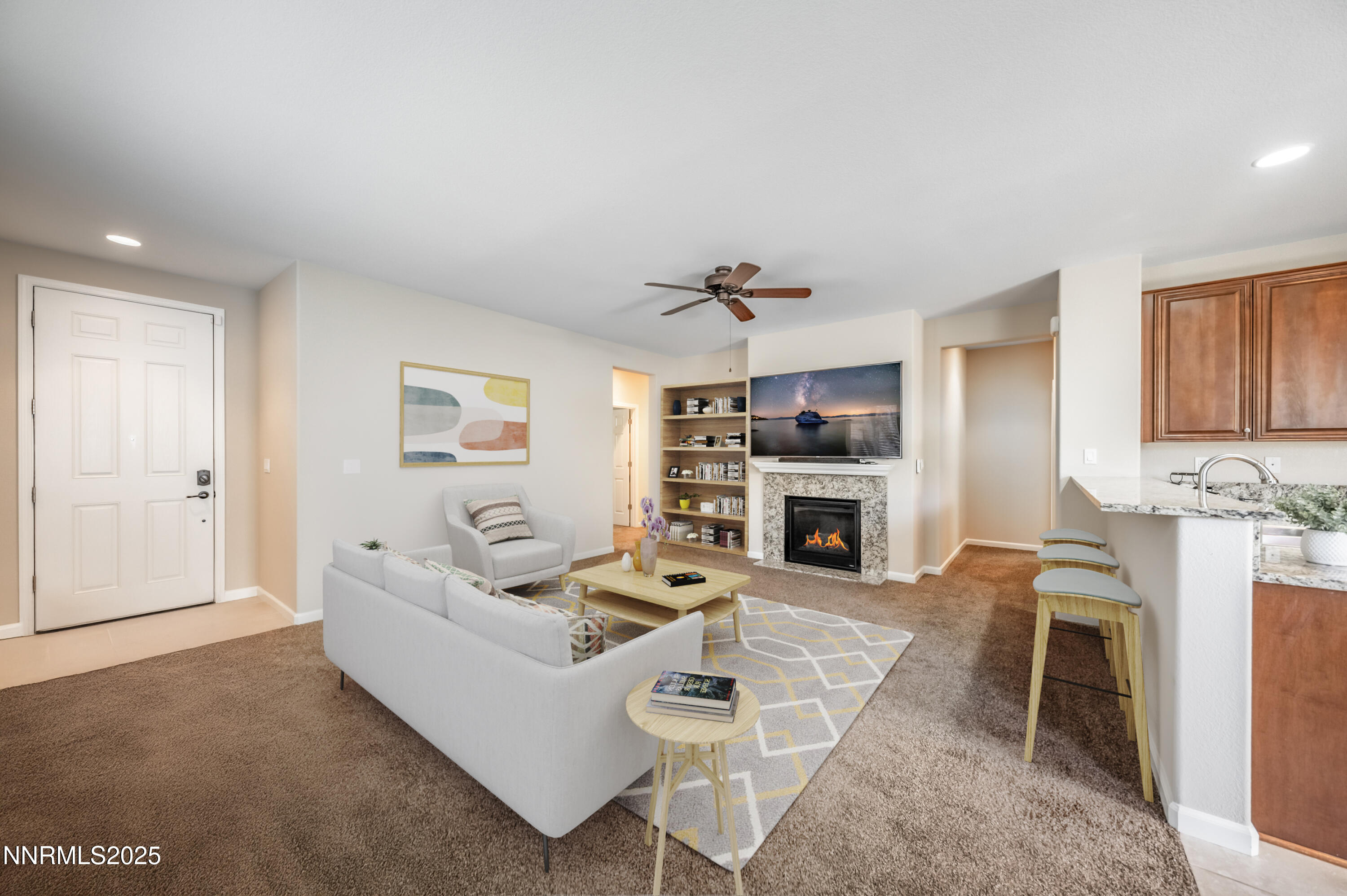 10742 Amber Falls Drive Reno, NV 89521 - Photo 7 of 28 a living room with furniture a fireplace and a flat screen tv
