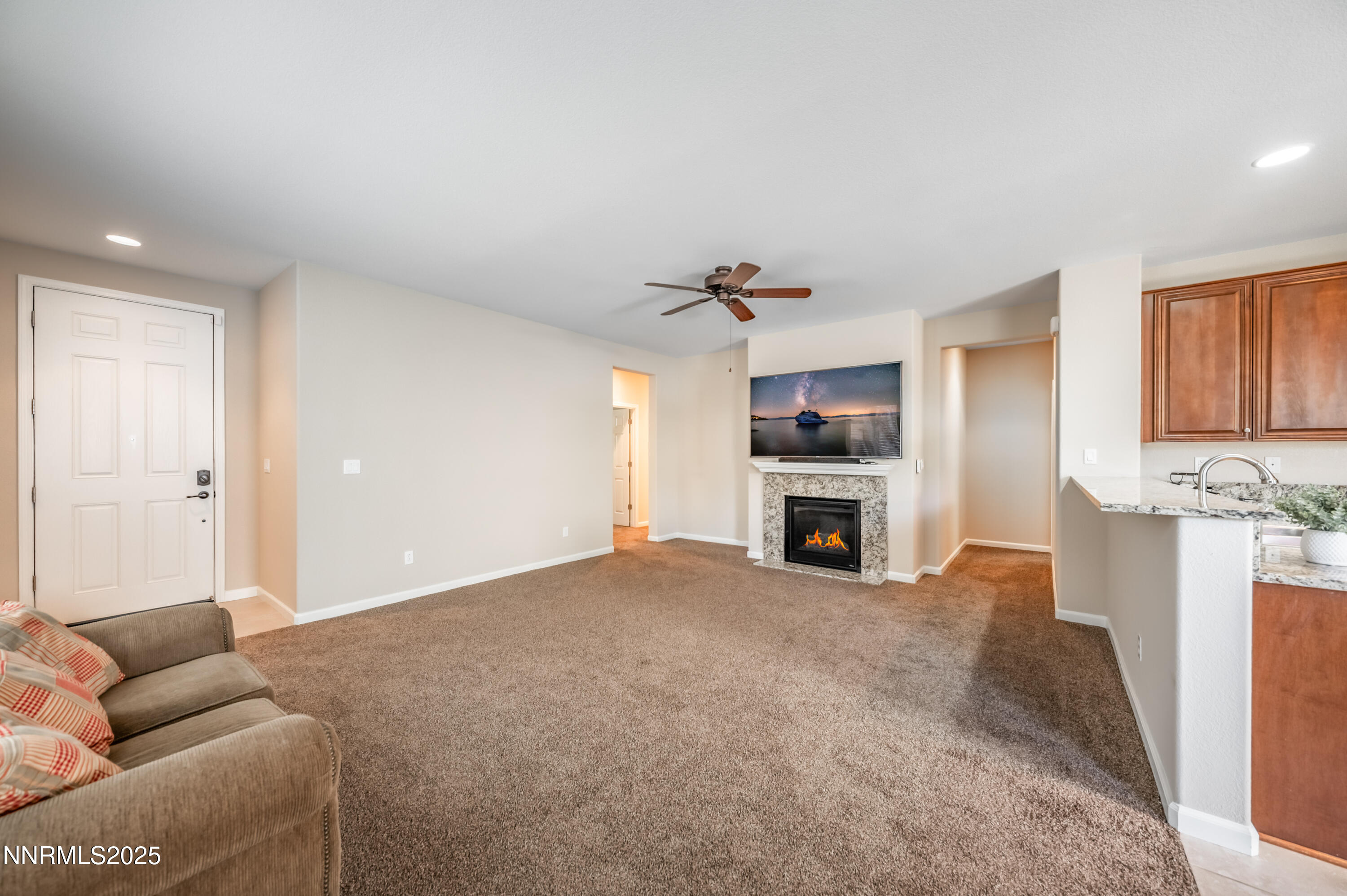 10742 Amber Falls Drive Reno, NV 89521 - Photo 8 of 28 a view of a livingroom with a fireplace and window