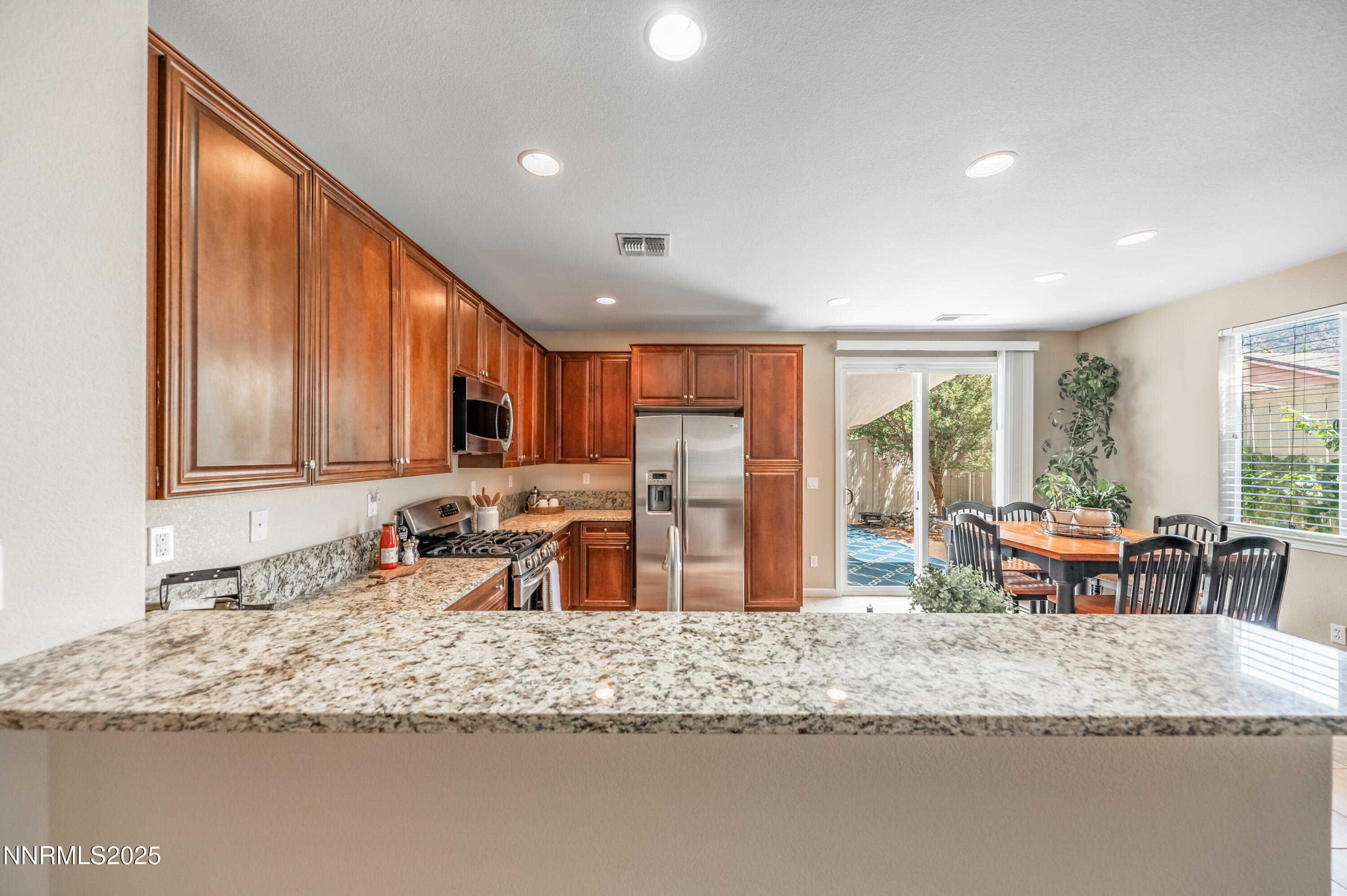 10742 Amber Falls Drive Reno, NV 89521 - Photo 9 of 28 a kitchen with granite countertop sink and granite counter top