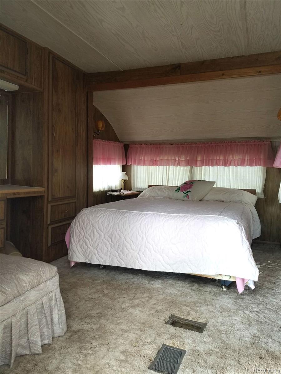 165 Baker Road Bailey, CO 80421 - Photo 2 of 20 a bedroom with a bed and window