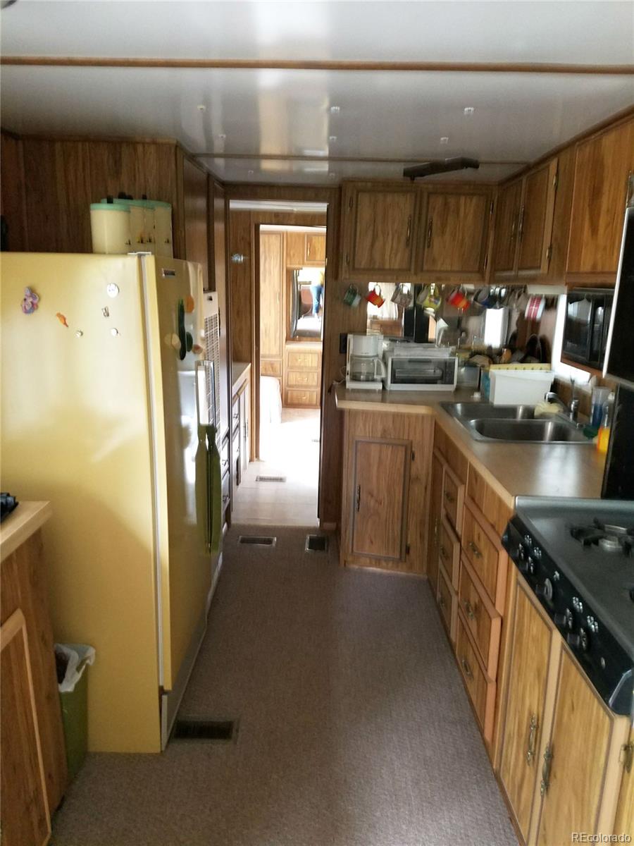 165 Baker Road Bailey, CO 80421 - Photo 8 of 20 a kitchen with a refrigerator and a stove
