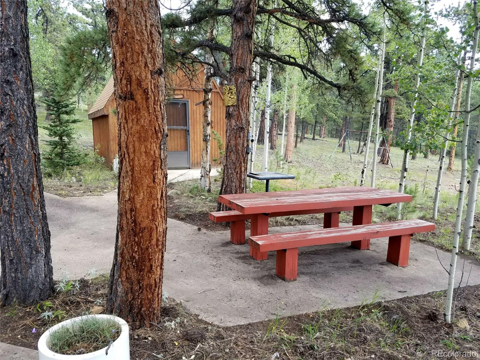 165 Baker Road Bailey, CO 80421 - Photo 10 of 20 a backyard of a house with outdoor seating