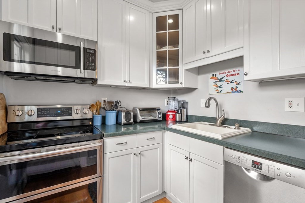 51 Franklin Street, Unit 51 Watertown, MA 02472 - Photo 7 of 15 a kitchen with granite countertop a sink stainless steel appliances and cabinets