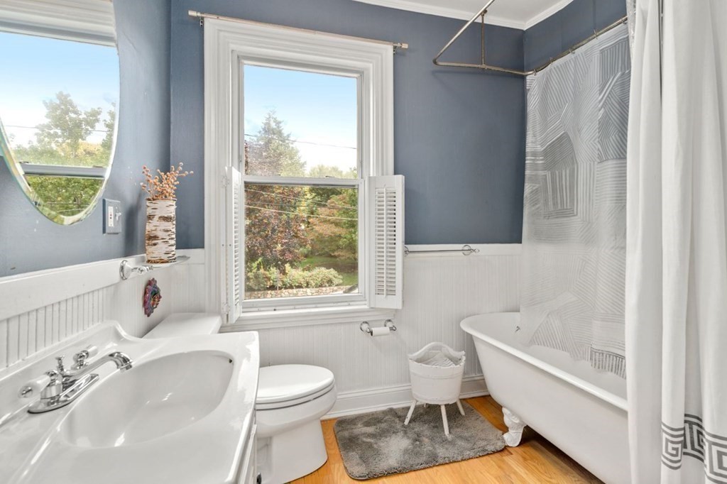 51 Franklin Street, Unit 51 Watertown, MA 02472 - Photo 10 of 15 a bathroom with a sink toilet a mirror and bathtub