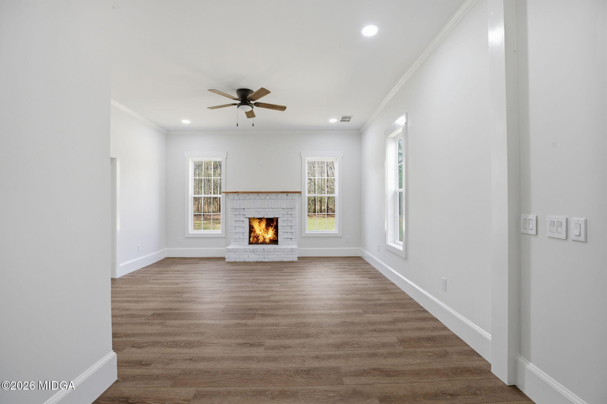3181 Dames Ferry Road Forsyth, GA 31029 - Photo 11 of 36 a view of empty room with a fireplace and wooden floor