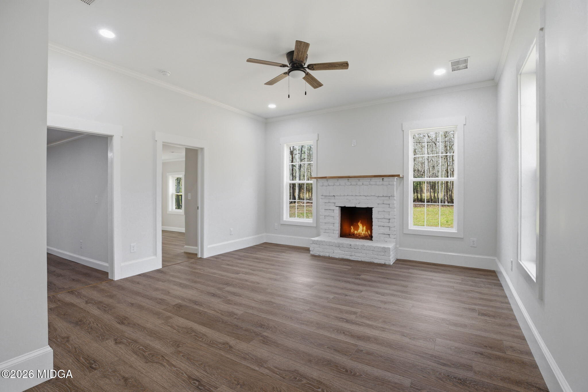 3181 Dames Ferry Road Forsyth, GA 31029 - Photo 12 of 36 a view of empty room with wooden floor and fireplace