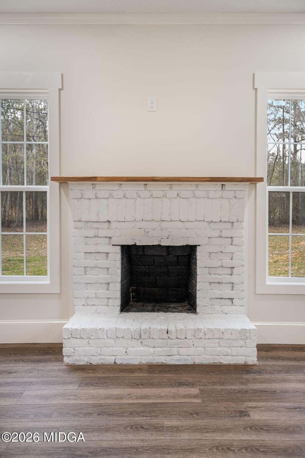 3181 Dames Ferry Road Forsyth, GA 31029 - Photo 14 of 36 a living room with a fireplace and a floor
