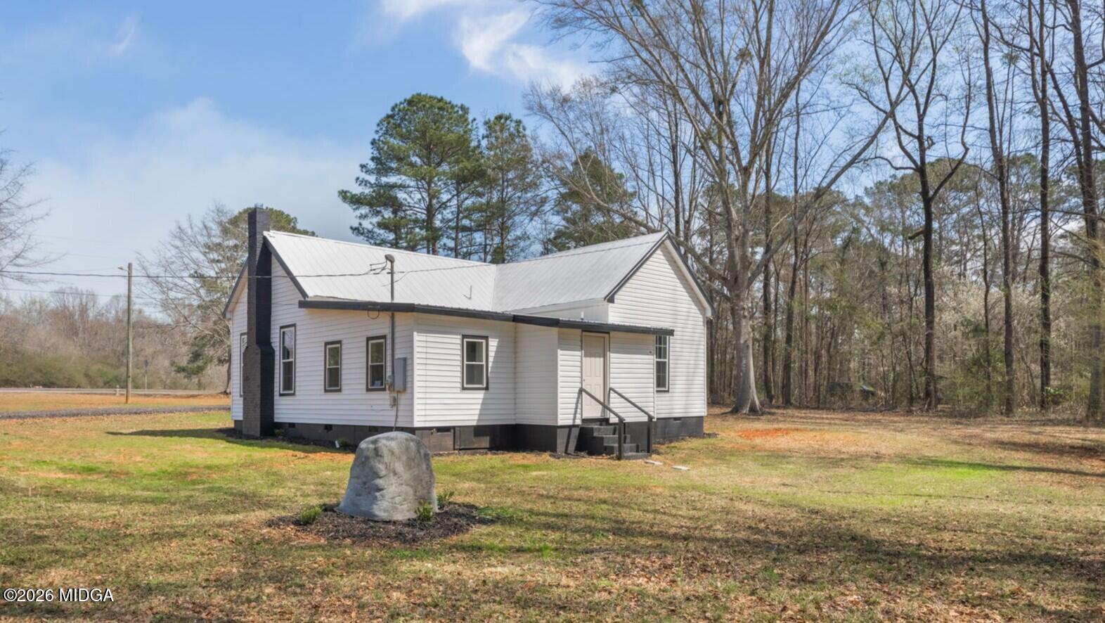 3181 Dames Ferry Road Forsyth, GA 31029 - Photo 2 of 36 a view of a house with backyard and tree