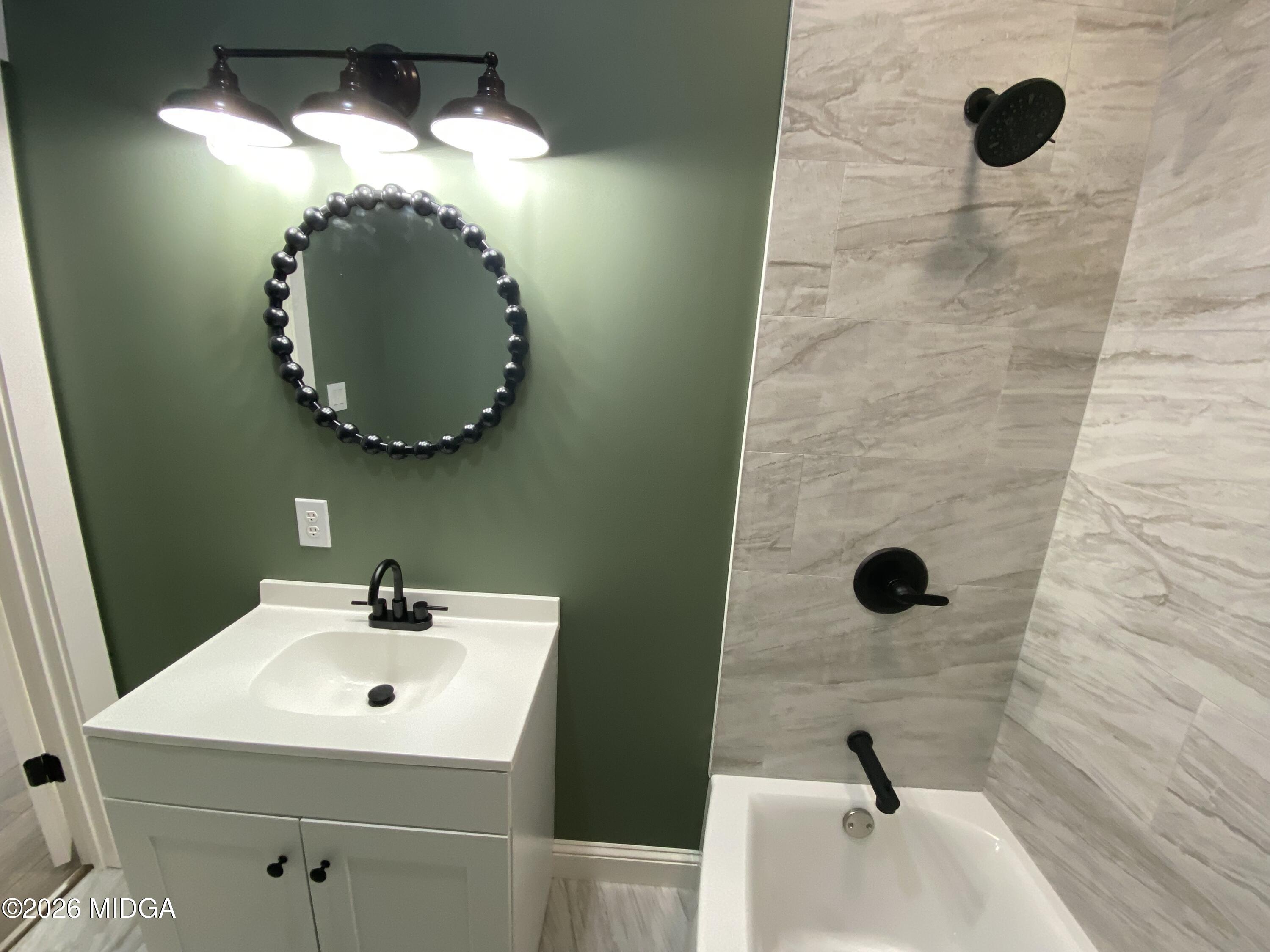 3181 Dames Ferry Road Forsyth, GA 31029 - Photo 23 of 36 a bathroom with a sink a mirror and shower