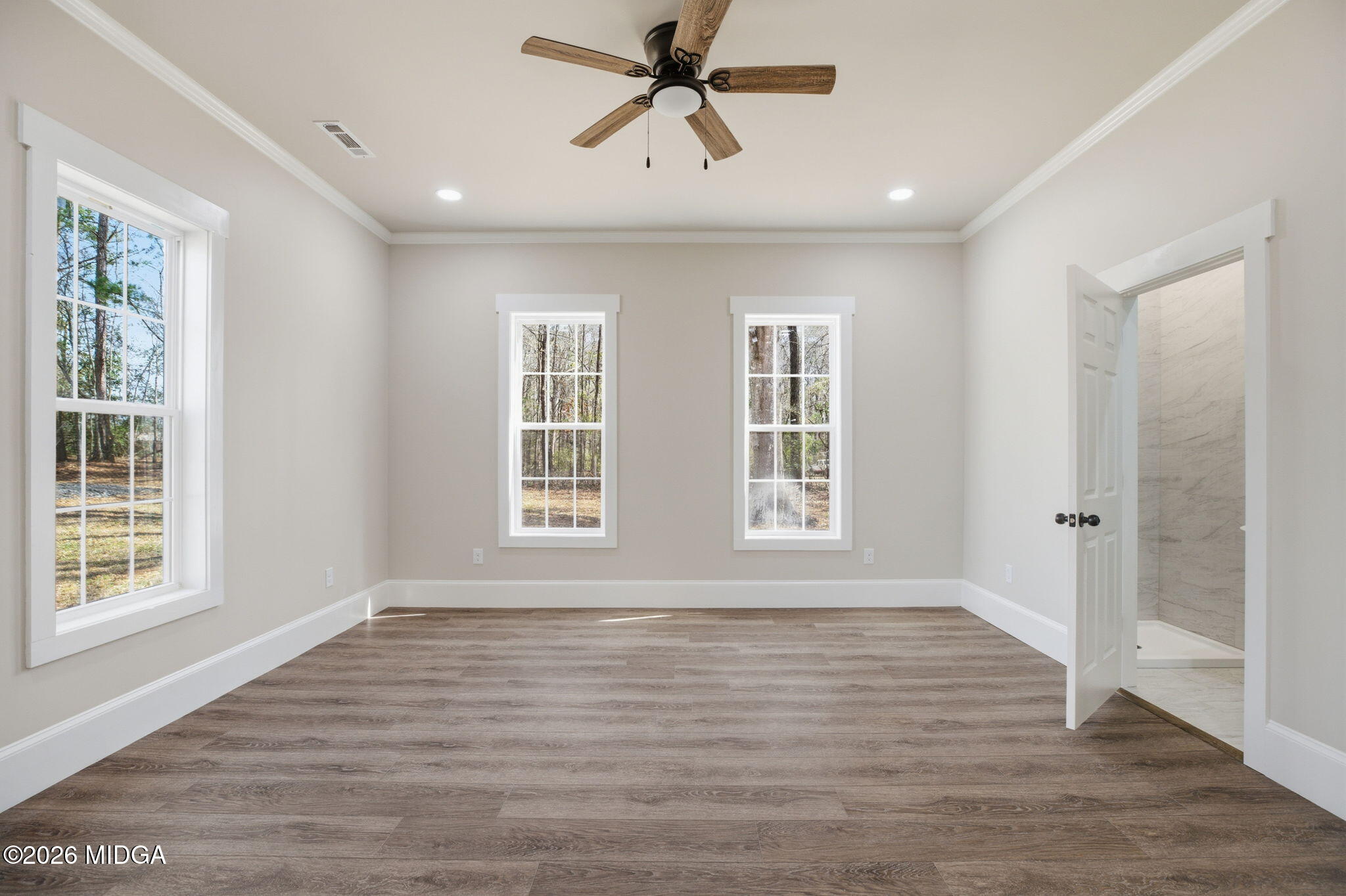 3181 Dames Ferry Road Forsyth, GA 31029 - Photo 25 of 36 a view of an empty room with wooden floor and a window