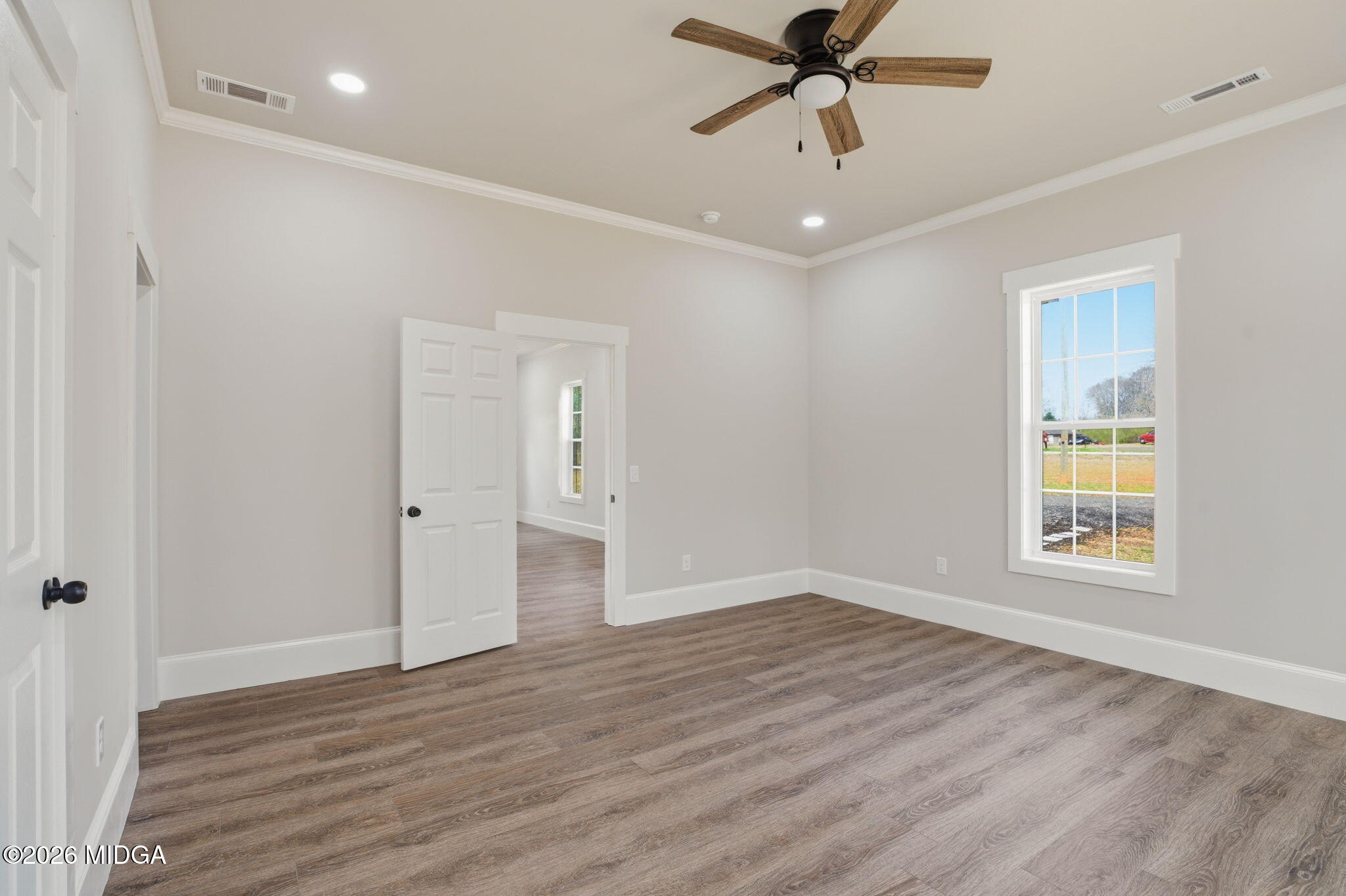 3181 Dames Ferry Road Forsyth, GA 31029 - Photo 27 of 36 a view of an empty room with a window and wooden floor
