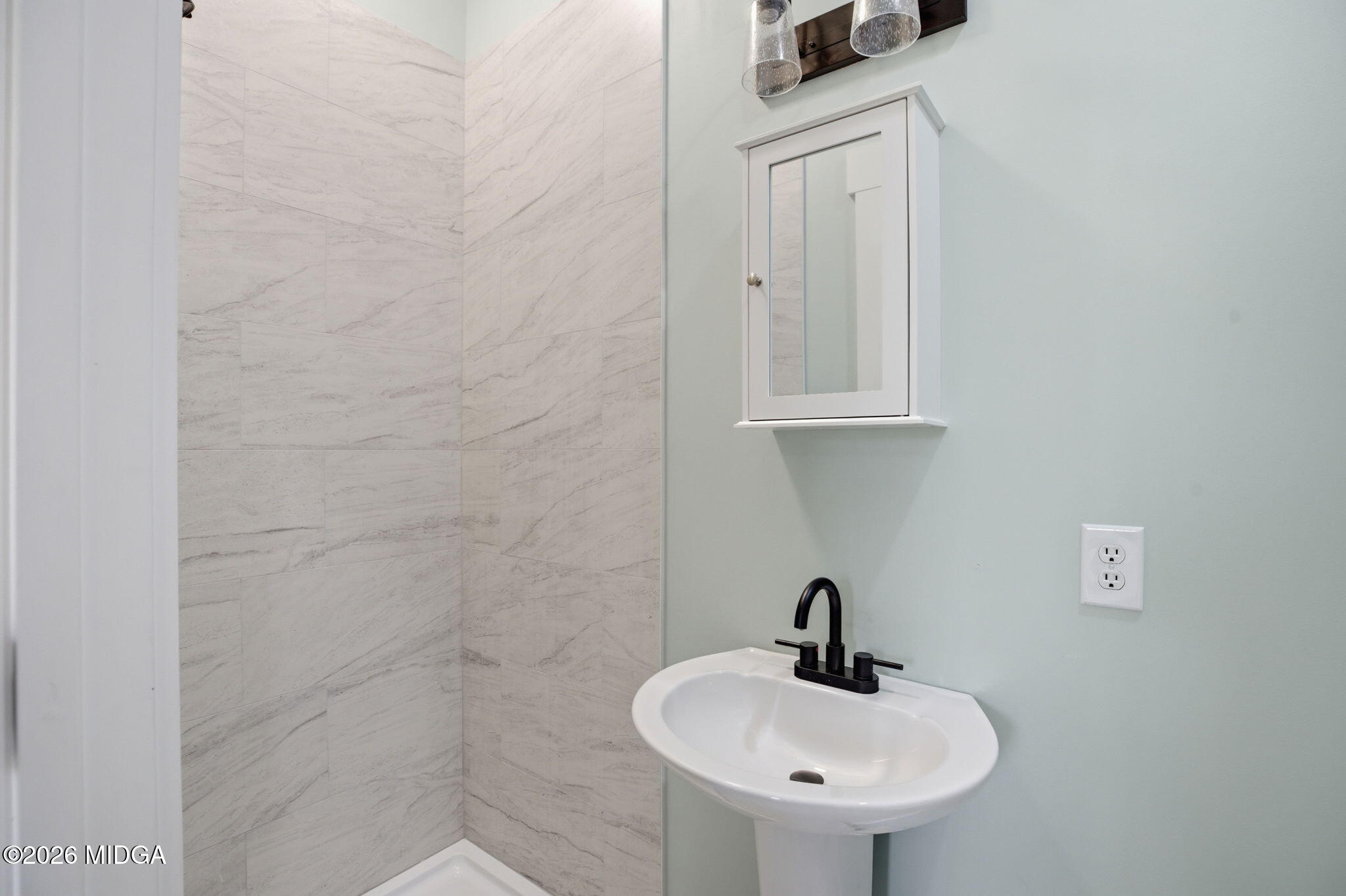 3181 Dames Ferry Road Forsyth, GA 31029 - Photo 28 of 36 a bathroom with a sink a mirror and vanity