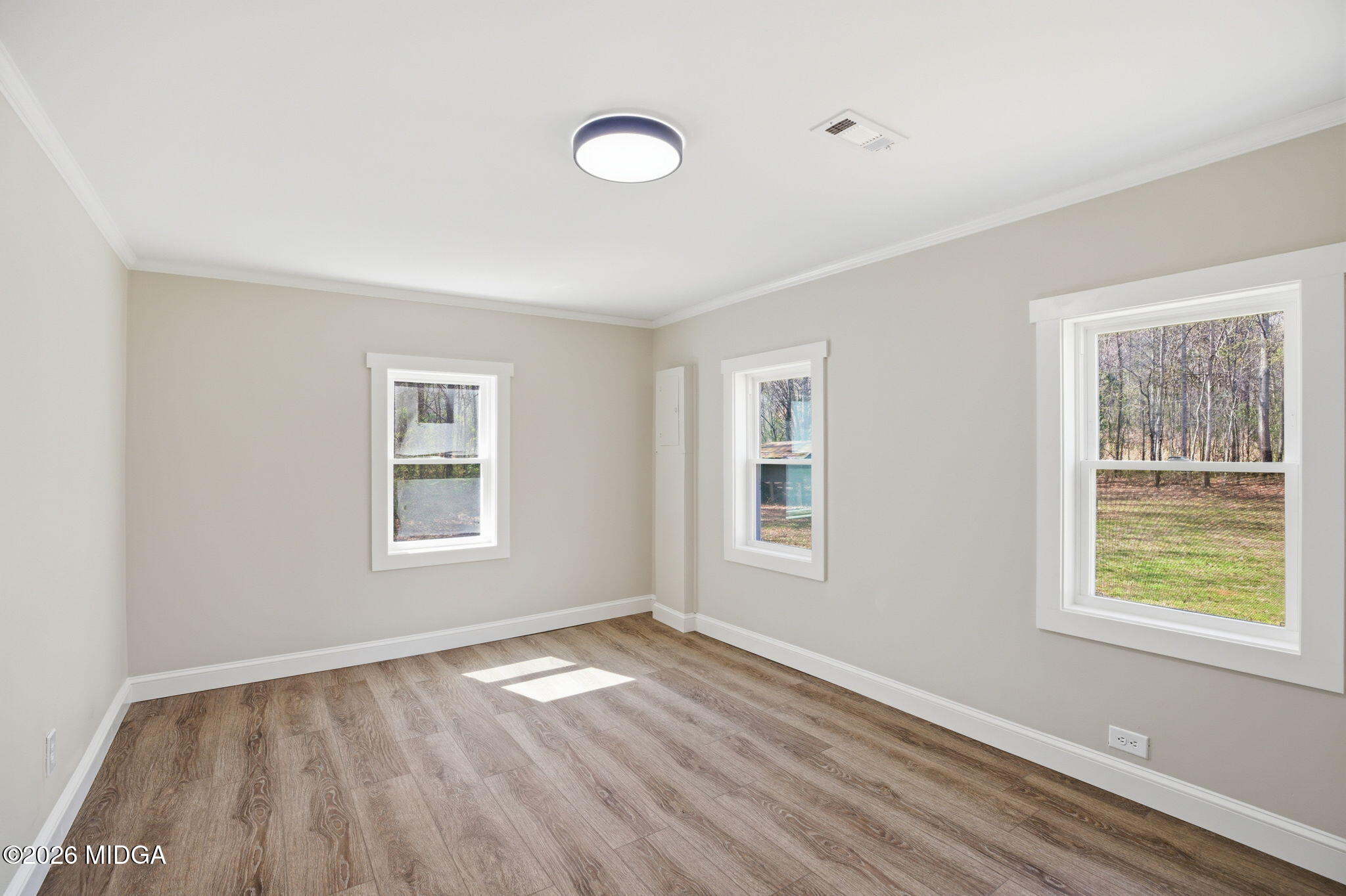 3181 Dames Ferry Road Forsyth, GA 31029 - Photo 30 of 36 a view of empty room with wooden floor and fan