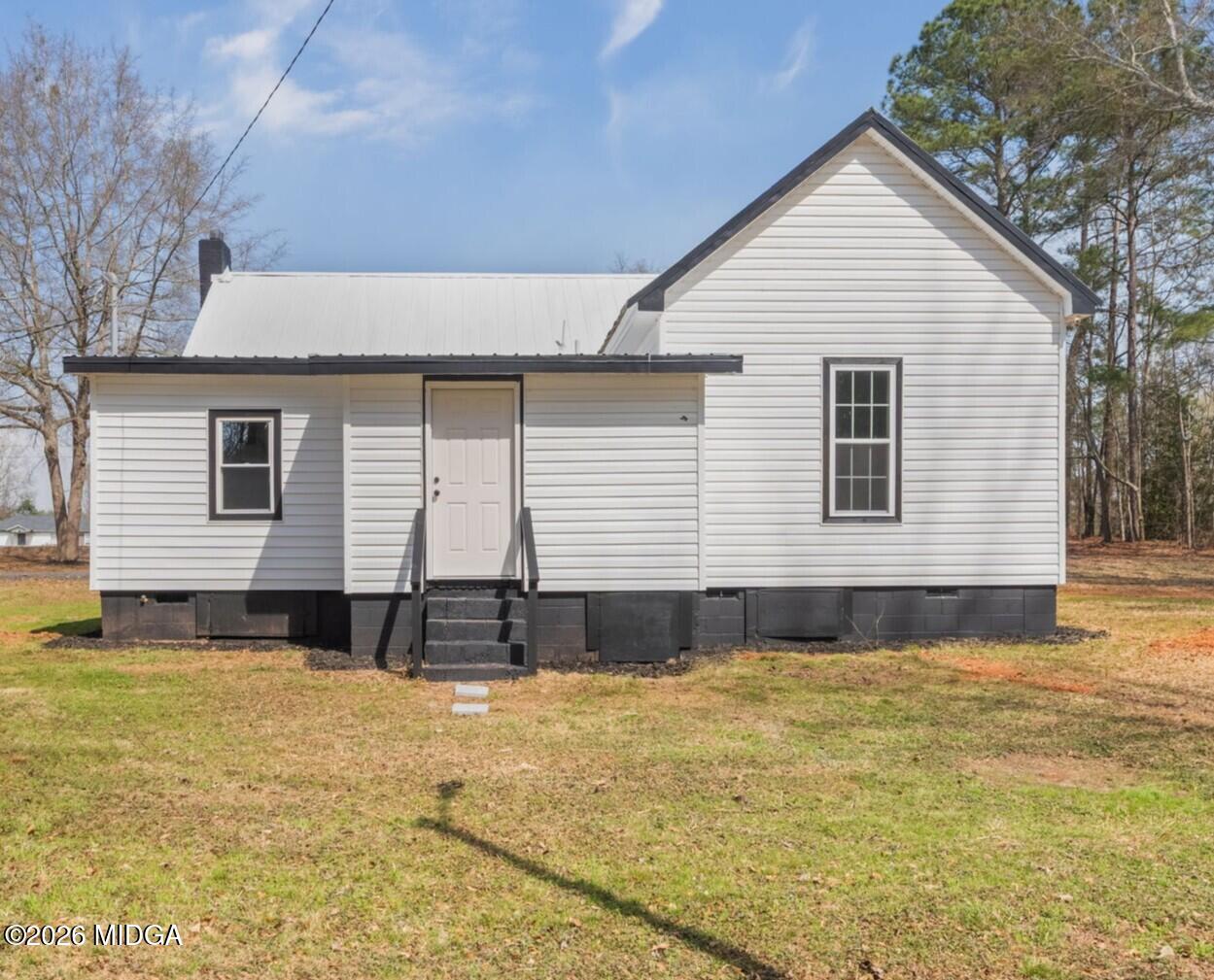 3181 Dames Ferry Road Forsyth, GA 31029 - Photo 3 of 36 a front view of a house with a yard