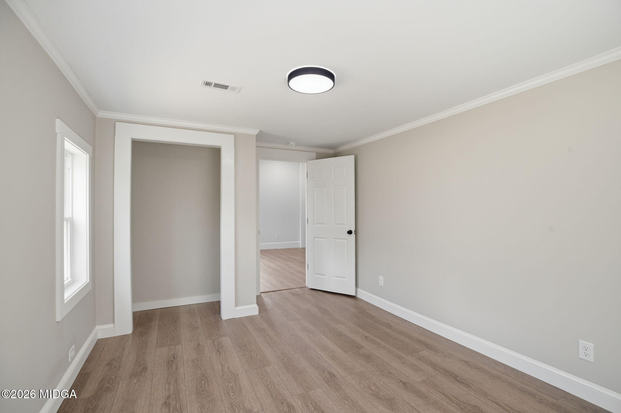 3181 Dames Ferry Road Forsyth, GA 31029 - Photo 31 of 36 an empty room with wooden floor and windows