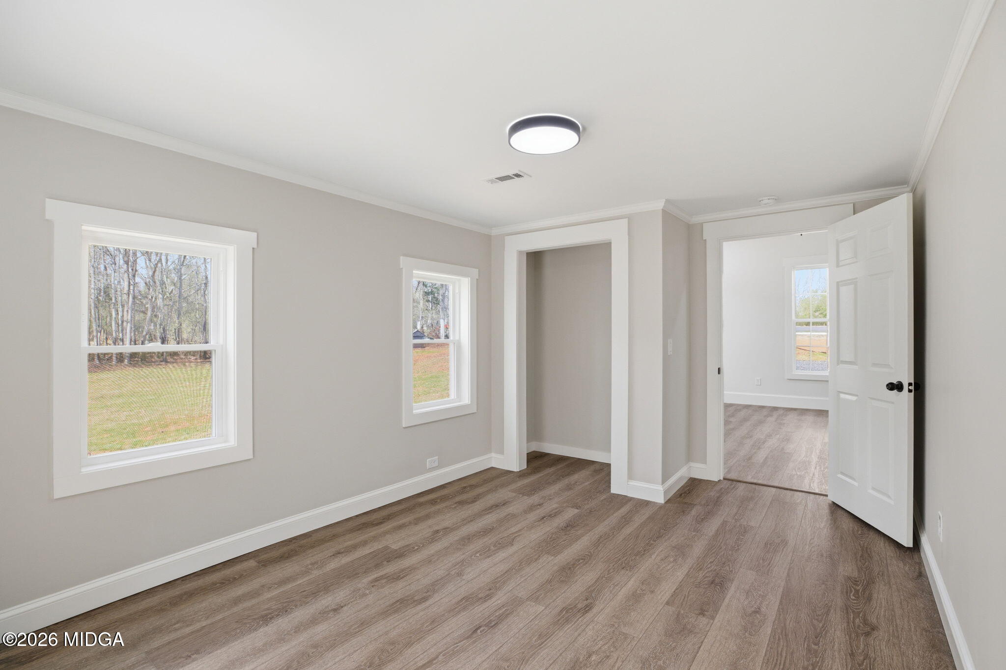 3181 Dames Ferry Road Forsyth, GA 31029 - Photo 32 of 36 a view of an empty room with wooden floor and a window