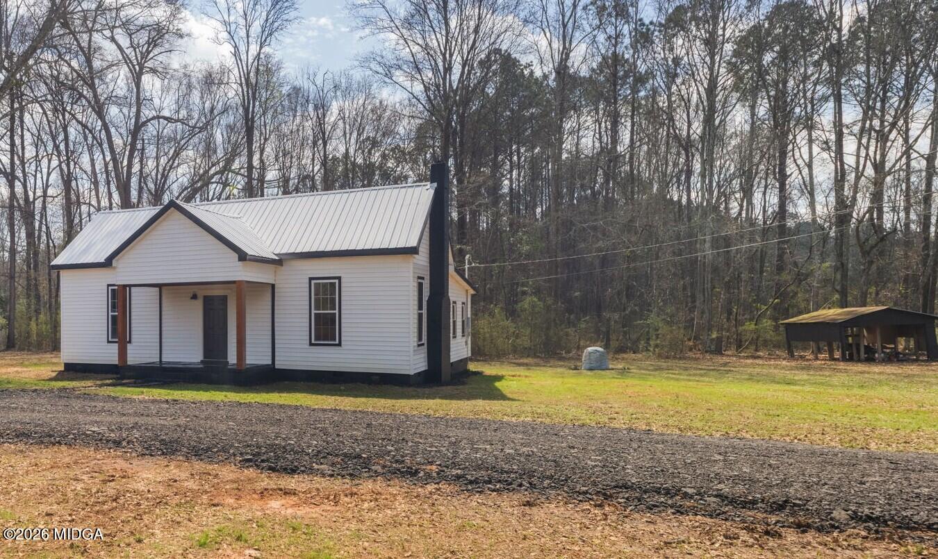 3181 Dames Ferry Road Forsyth, GA 31029 - Photo 4 of 36 a view of a house with backyard and tree