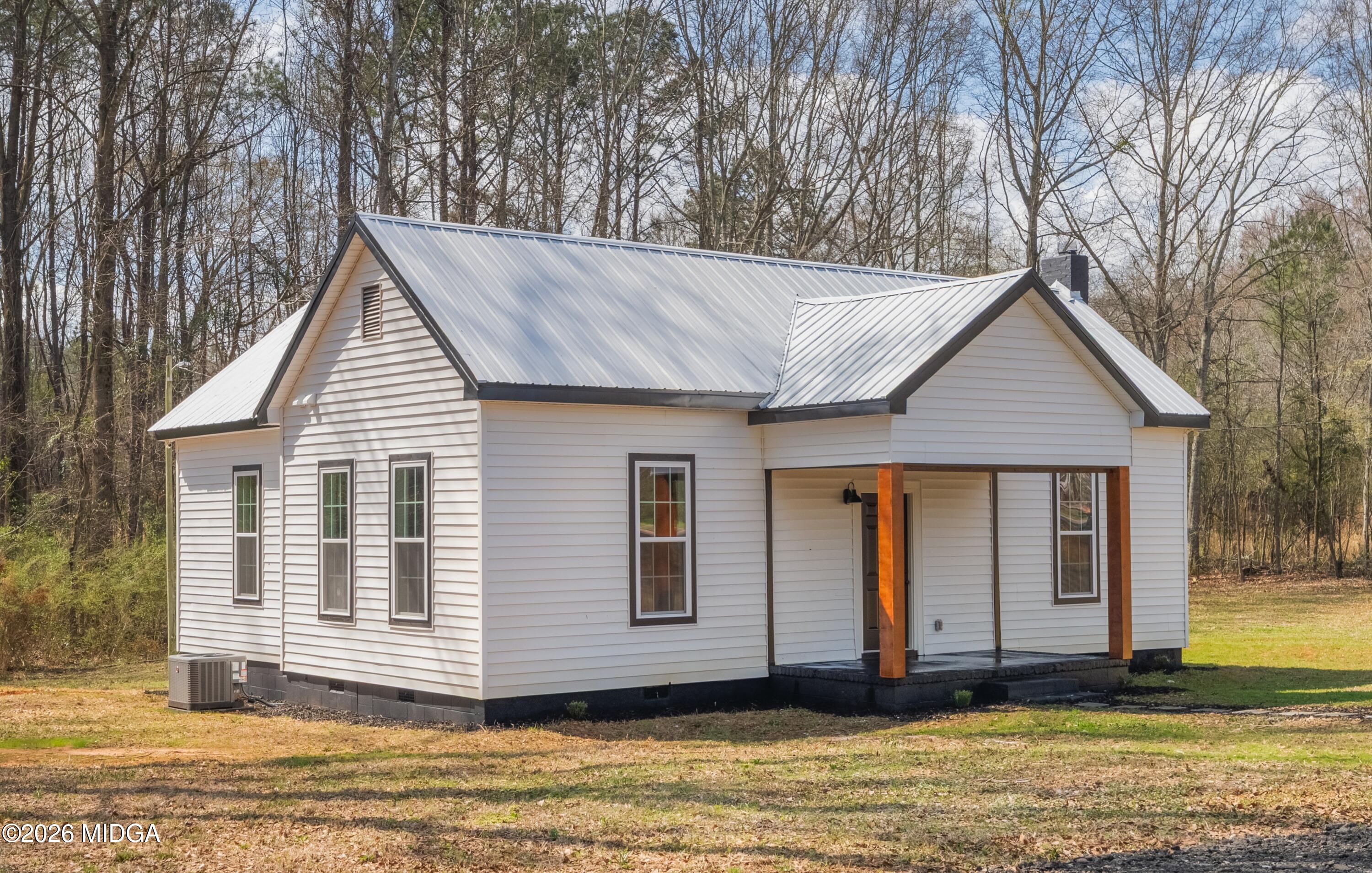 3181 Dames Ferry Road Forsyth, GA 31029 - Photo 5 of 36 a house view with a garden space