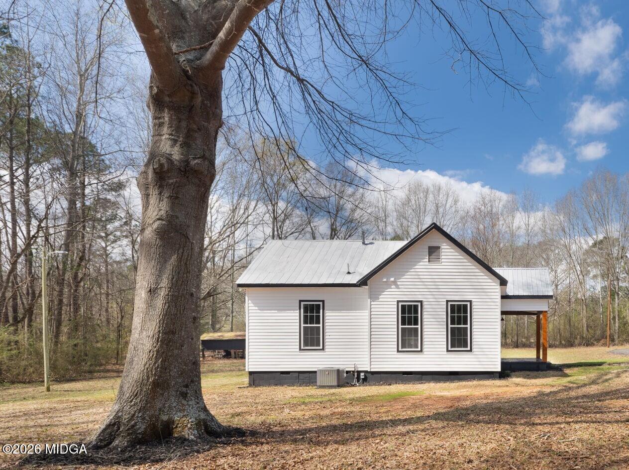 3181 Dames Ferry Road Forsyth, GA 31029 - Photo 6 of 36 a front view of a house with a yard