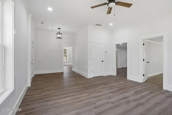 a view of an empty room with wooden floor