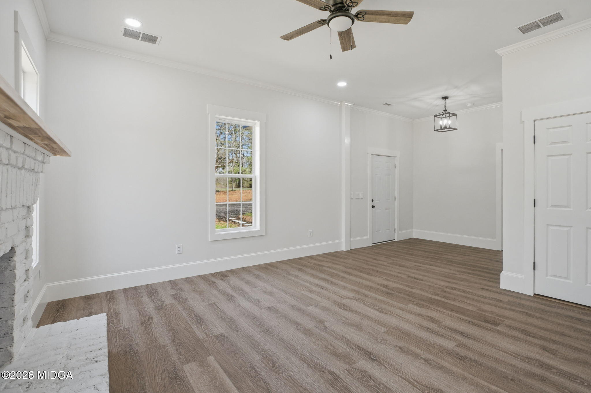 3181 Dames Ferry Road Forsyth, GA 31029 - Photo 10 of 36 wooden floor in an empty room with a window