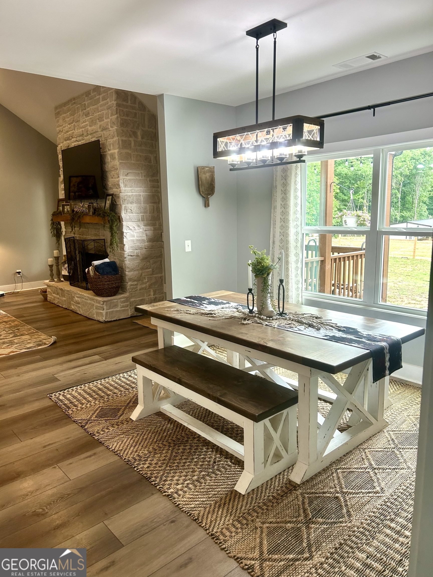 1250 Godfrey Road Madison, GA 30650 - Photo 22 of 42 a kitchen with a stove and a chandelier