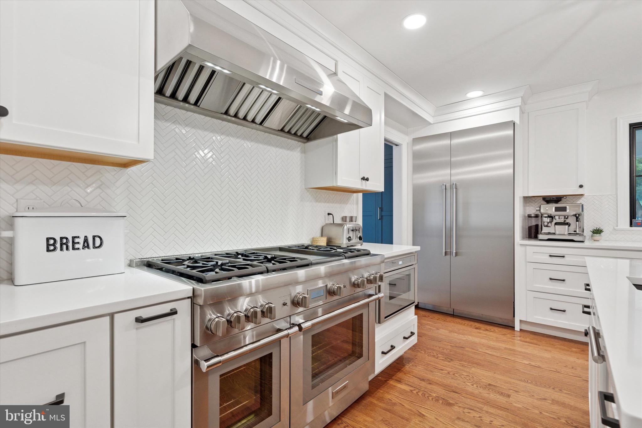 610 Dorset Road Devon, PA 19333 - Photo 24 of 54 a kitchen with stainless steel appliances granite countertop a stove and a refrigerator