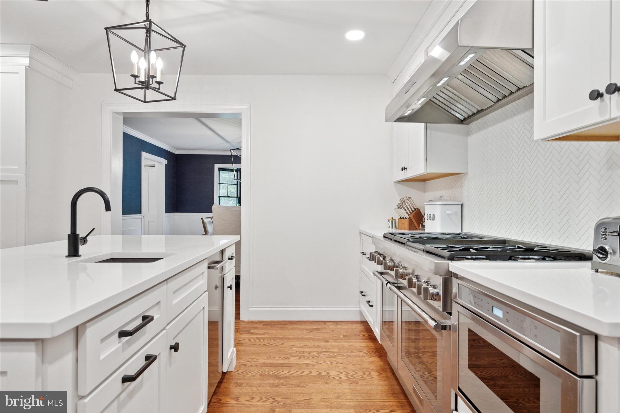 610 Dorset Road Devon, PA 19333 - Photo 27 of 54 a kitchen with stainless steel appliances granite countertop a stove and a sink
