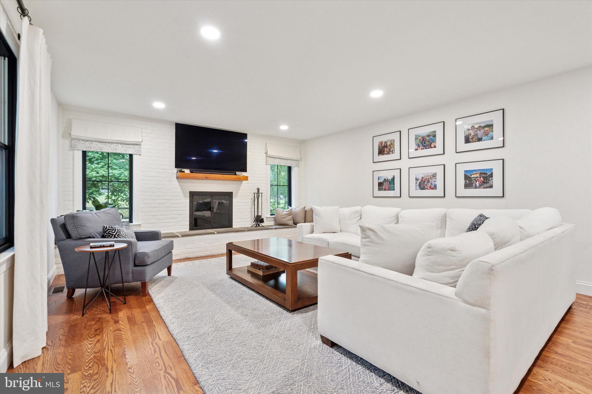 610 Dorset Road Devon, PA 19333 - Photo 31 of 54 a living room with furniture a fireplace and a flat screen tv
