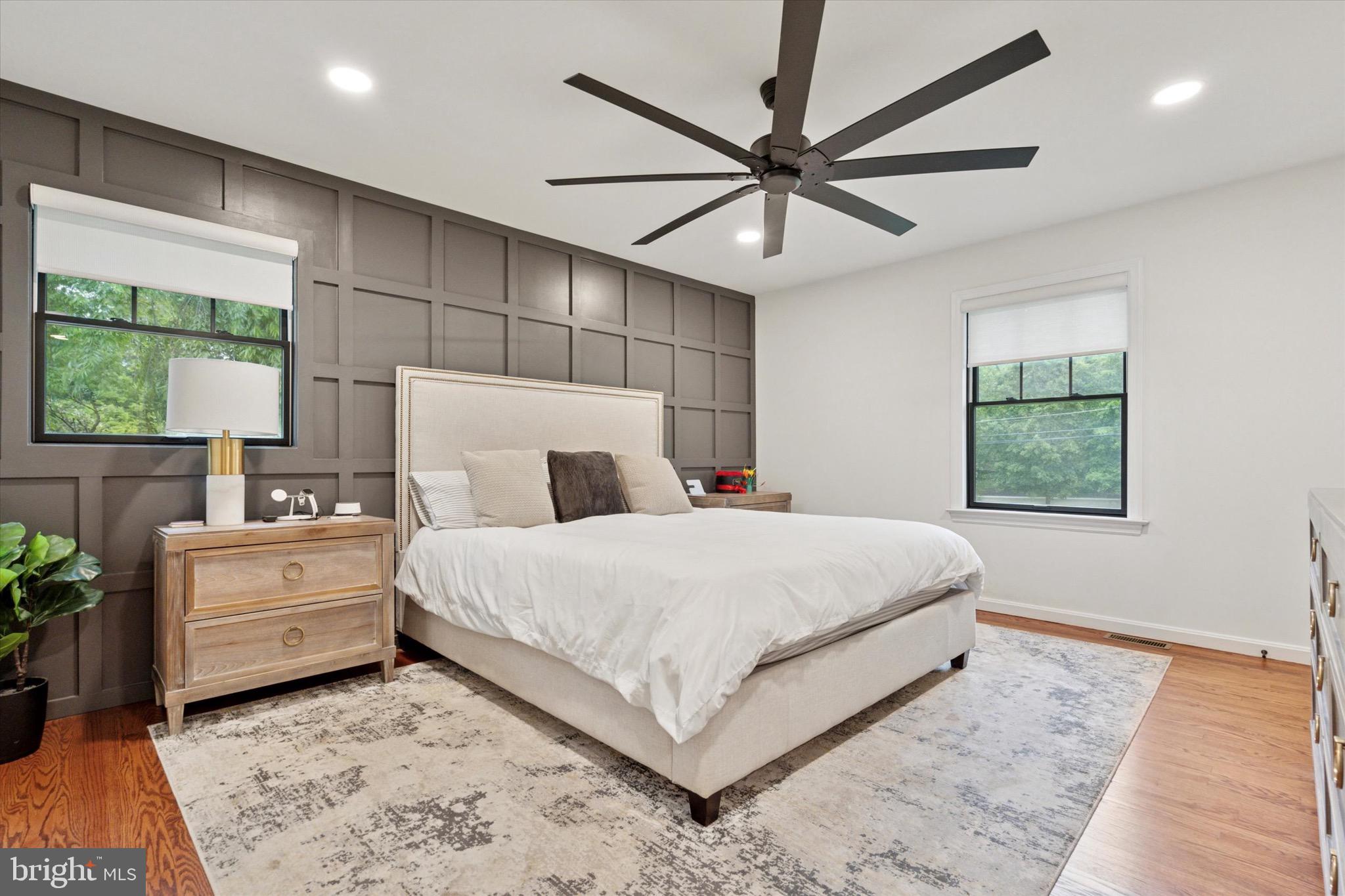 610 Dorset Road Devon, PA 19333 - Photo 39 of 54 a bedroom with a large bed and a chandelier