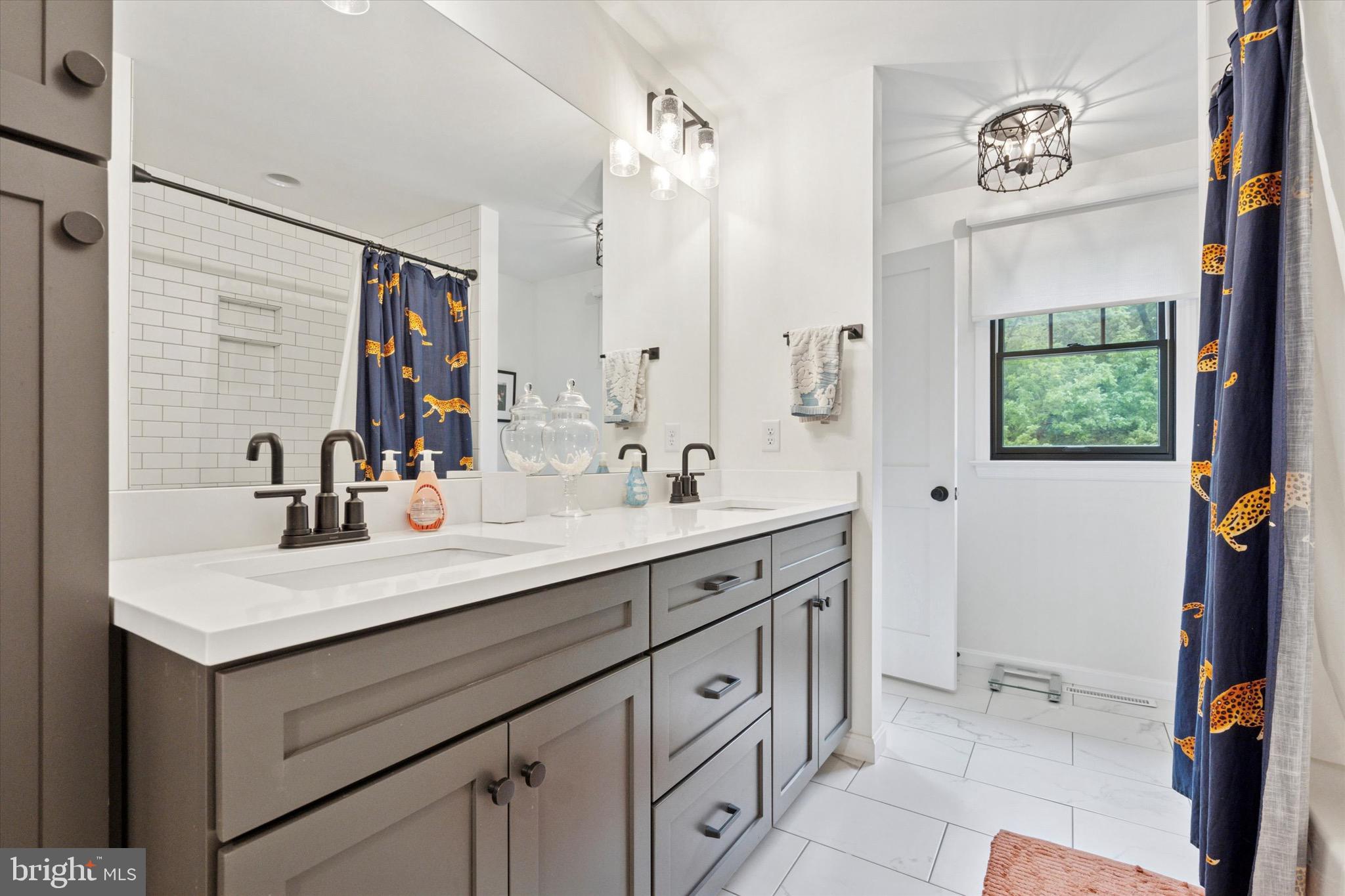 610 Dorset Road Devon, PA 19333 - Photo 41 of 54 a bathroom with a sink vanity granite and a mirror