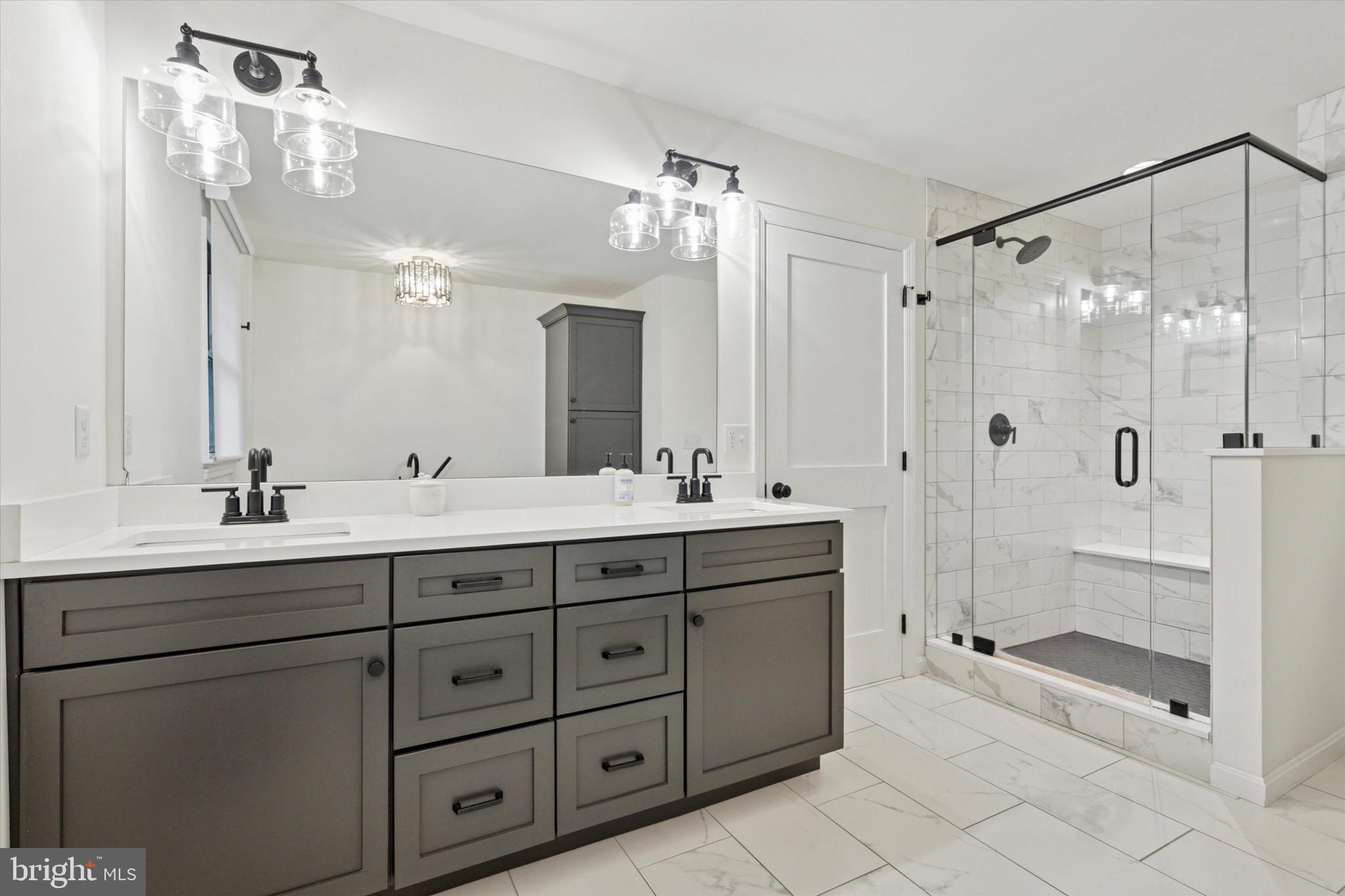 610 Dorset Road Devon, PA 19333 - Photo 42 of 54 a bathroom with double vanity sinks and a shower