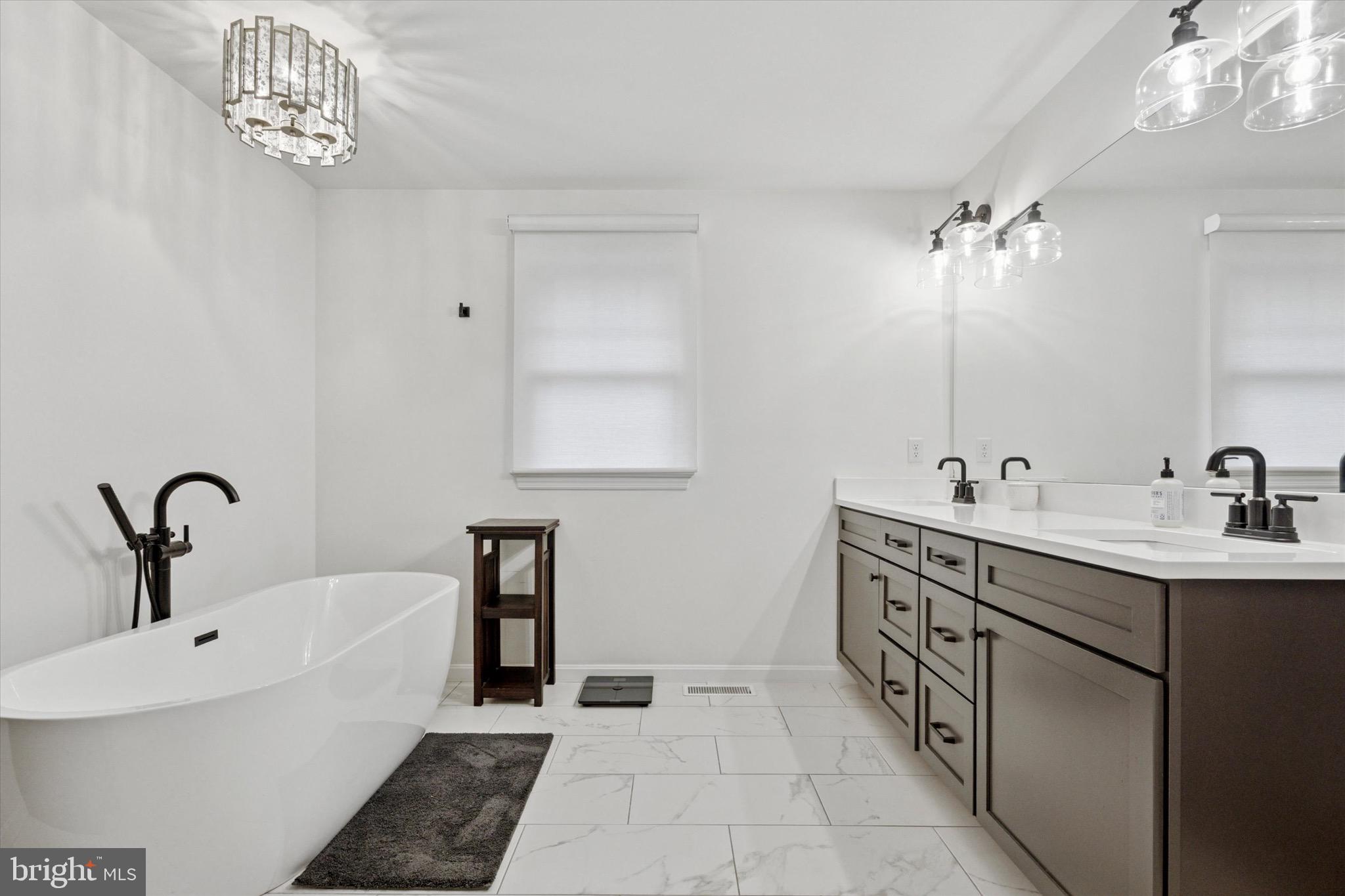 610 Dorset Road Devon, PA 19333 - Photo 43 of 54 a bathroom with a double vanity sink and a mirror