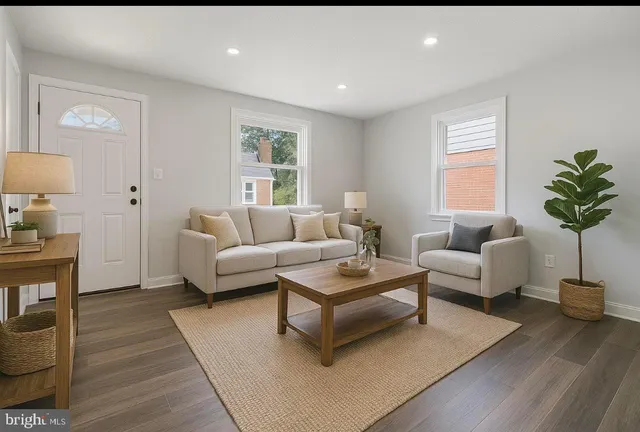a living room with furniture and a wooden floor