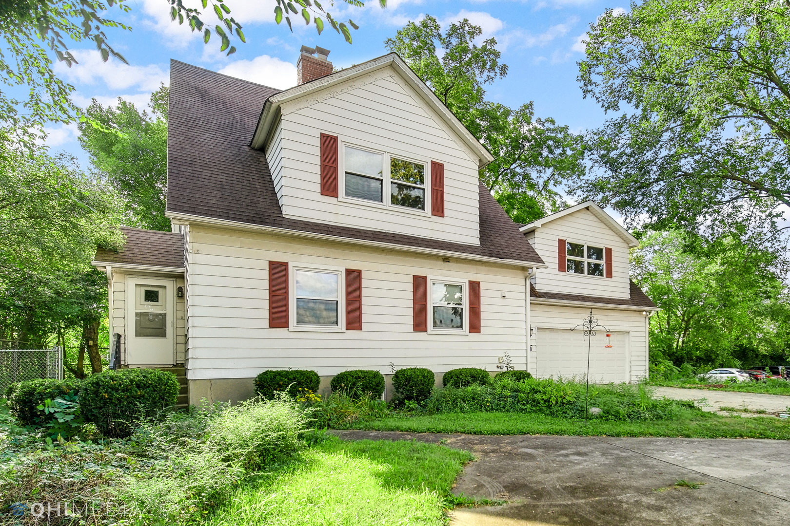 a view of a house with a yard and large tree